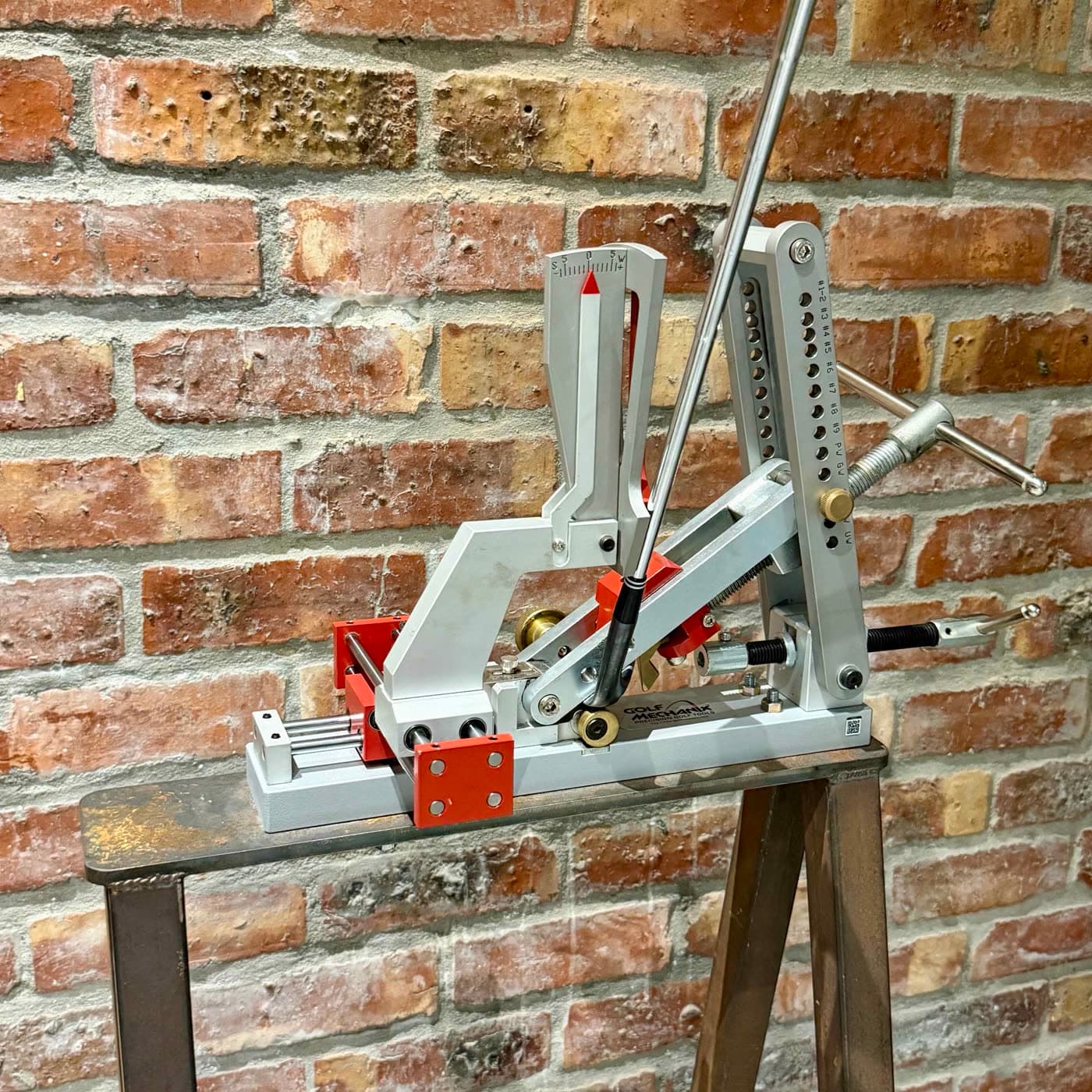 The loft and lie bending machine mounted against the brick wall