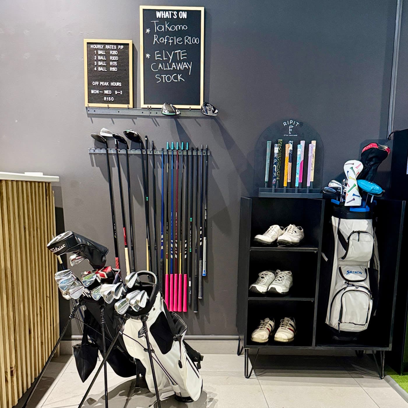 The retail wall with clubs, shoes and bags, and the what is on board