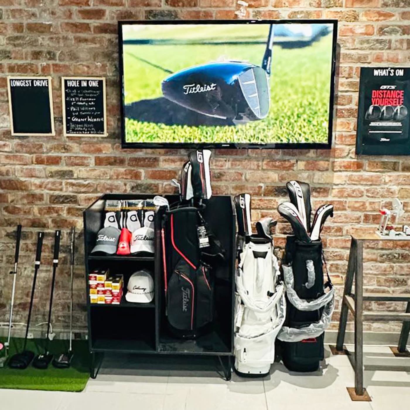 The lounge area, brick wall and screen showing tour footage